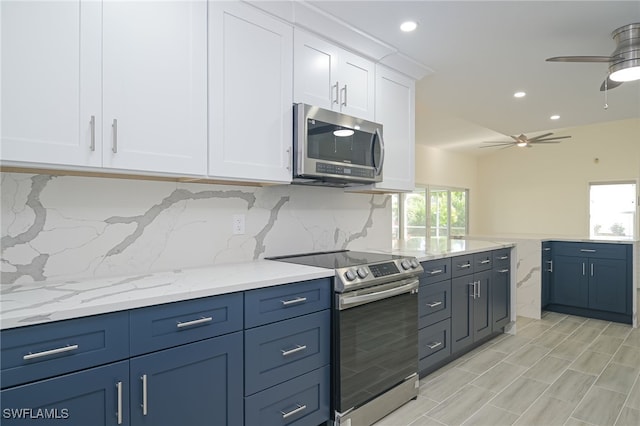 kitchen featuring backsplash, white cabinetry, blue cabinets, appliances with stainless steel finishes, and ceiling fan