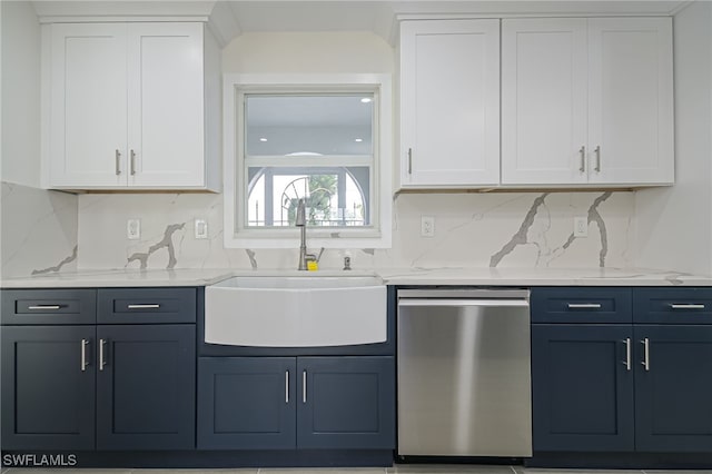 kitchen featuring sink, white cabinetry, light stone counters, stainless steel dishwasher, and backsplash