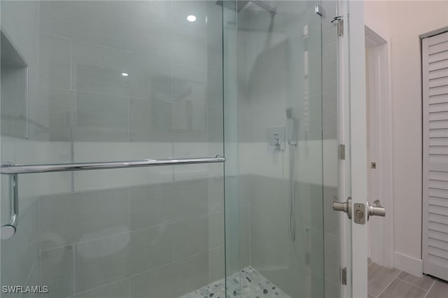 bathroom featuring a shower with door