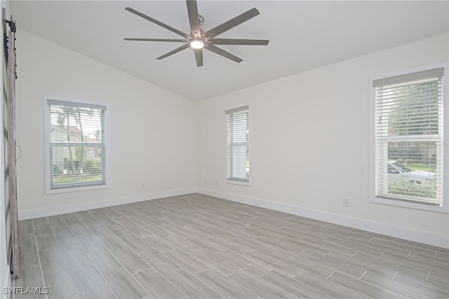 unfurnished room featuring a healthy amount of sunlight, ceiling fan, and lofted ceiling