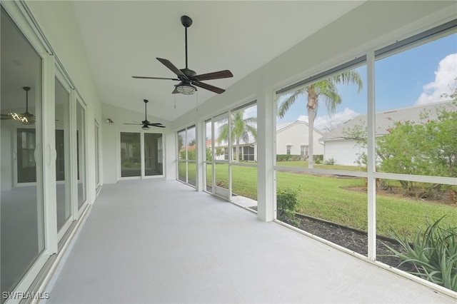 unfurnished sunroom featuring ceiling fan and vaulted ceiling