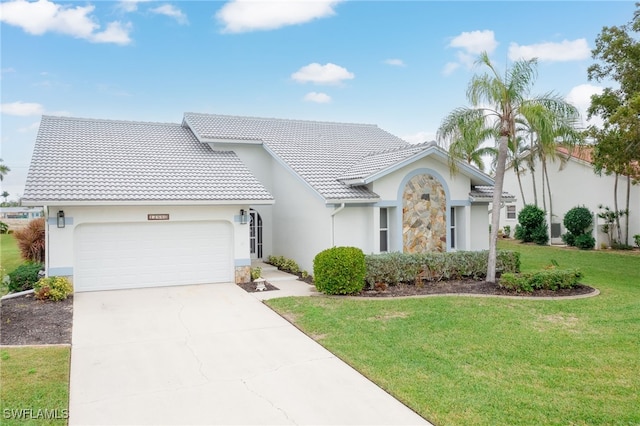 view of front of house featuring a garage and a front lawn