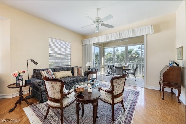 living room featuring ceiling fan and light hardwood / wood-style flooring