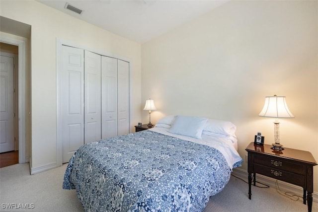 carpeted bedroom featuring a closet