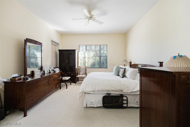 carpeted bedroom with ceiling fan and multiple windows