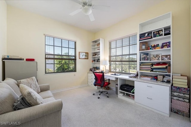 office space with light colored carpet and ceiling fan