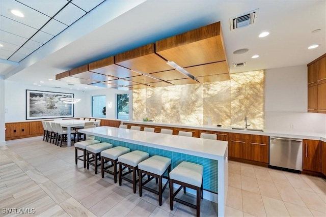 kitchen with sink, a kitchen breakfast bar, and dishwasher