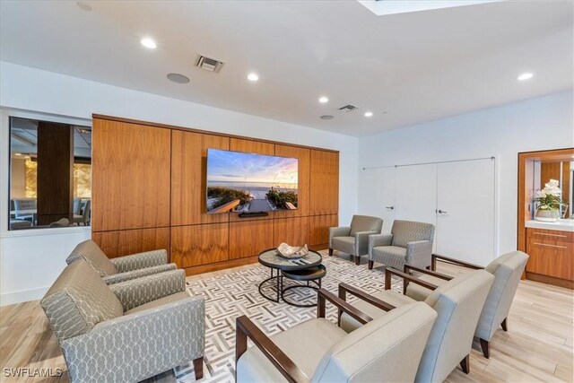 cinema room with light hardwood / wood-style flooring