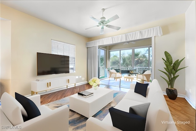 living room featuring hardwood / wood-style flooring and ceiling fan