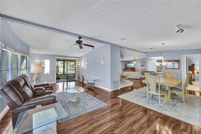 living room with plenty of natural light, ceiling fan with notable chandelier, and a textured ceiling