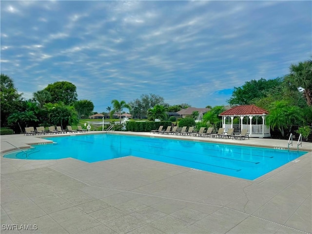 view of swimming pool featuring a patio and a gazebo