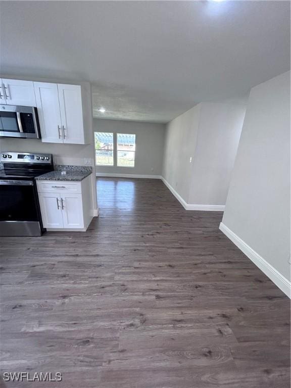 kitchen featuring white cabinets, dark wood-type flooring, and appliances with stainless steel finishes