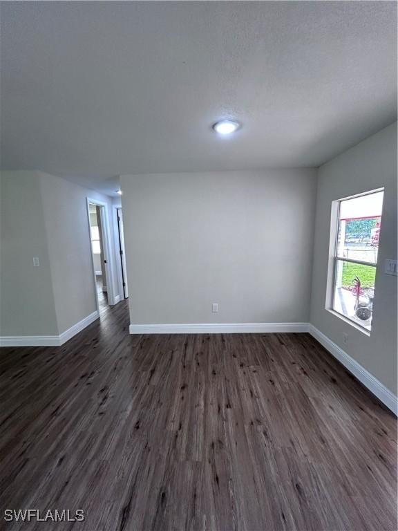 unfurnished room featuring dark hardwood / wood-style floors