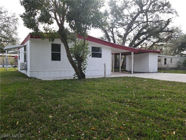 rear view of property with a yard and a carport