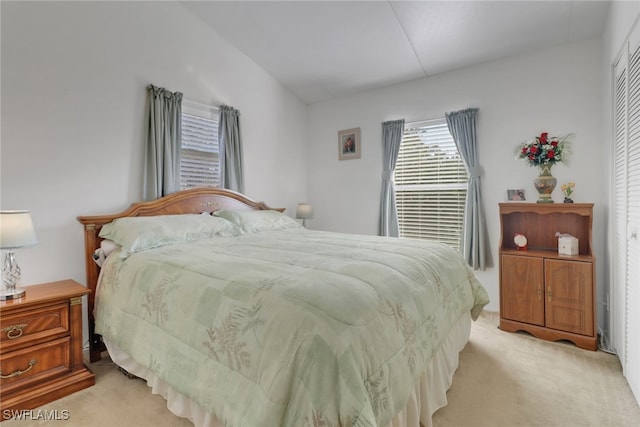 bedroom featuring light colored carpet