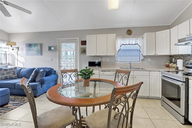 kitchen with sink, light tile patterned floors, stainless steel appliances, and white cabinets