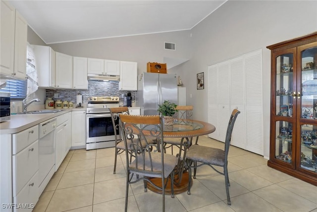 kitchen featuring white cabinetry, lofted ceiling, appliances with stainless steel finishes, and sink