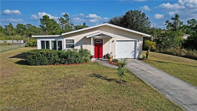 single story home featuring a garage and a front lawn