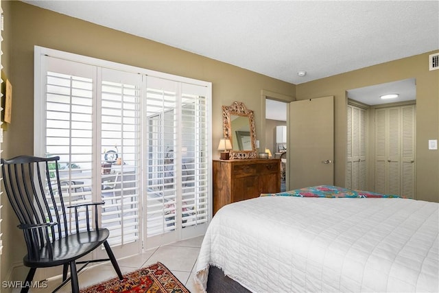 tiled bedroom with a closet