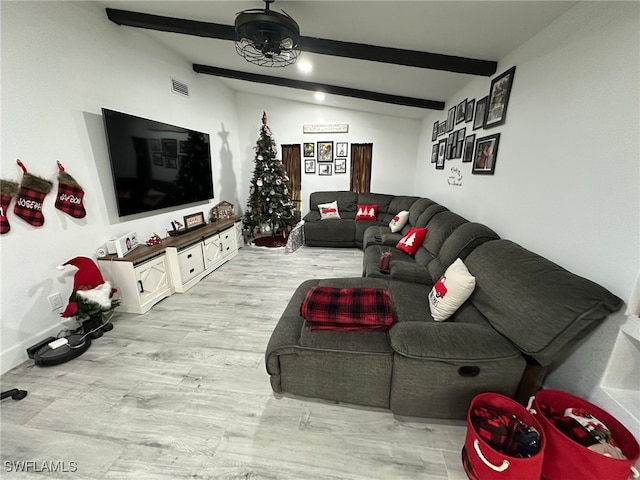 living room with lofted ceiling with beams and light hardwood / wood-style flooring