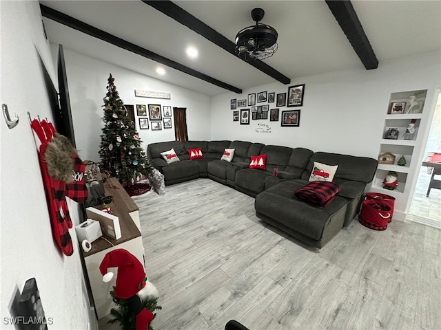 living room with built in features, vaulted ceiling with beams, and wood-type flooring