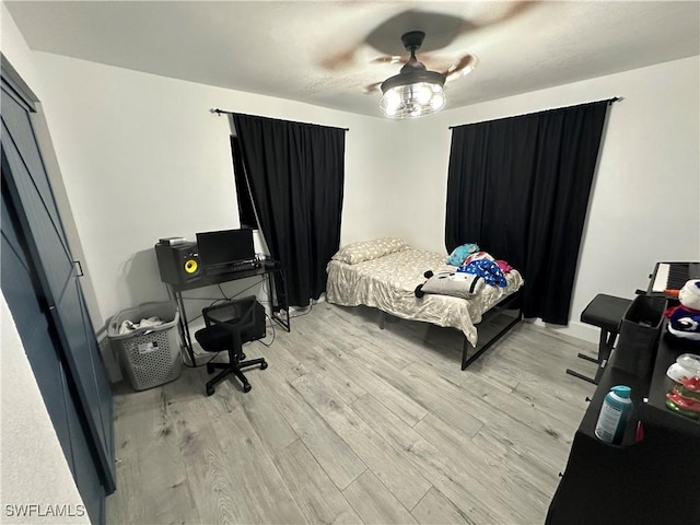 bedroom with ceiling fan and light hardwood / wood-style floors