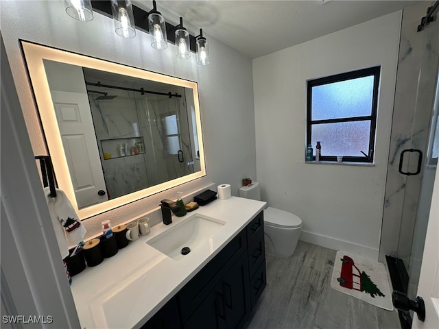 bathroom featuring toilet, hardwood / wood-style flooring, walk in shower, and vanity