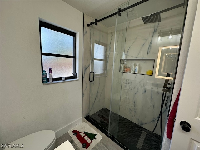 bathroom featuring walk in shower and toilet