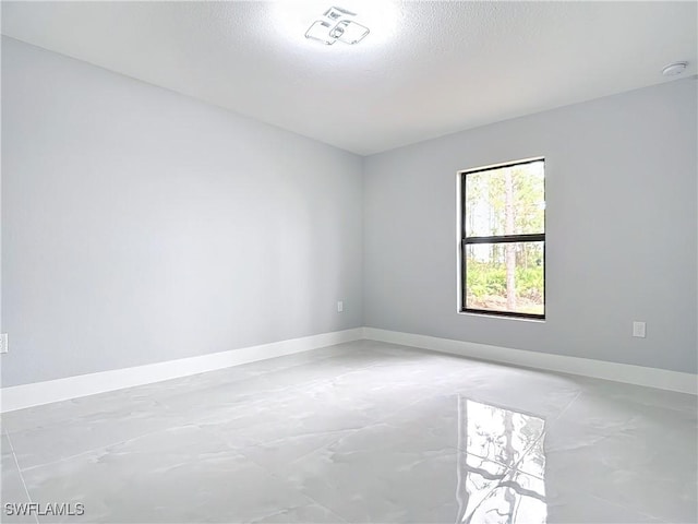 spare room with a textured ceiling