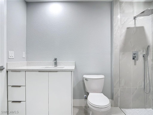 bathroom with toilet, vanity, and walk in shower