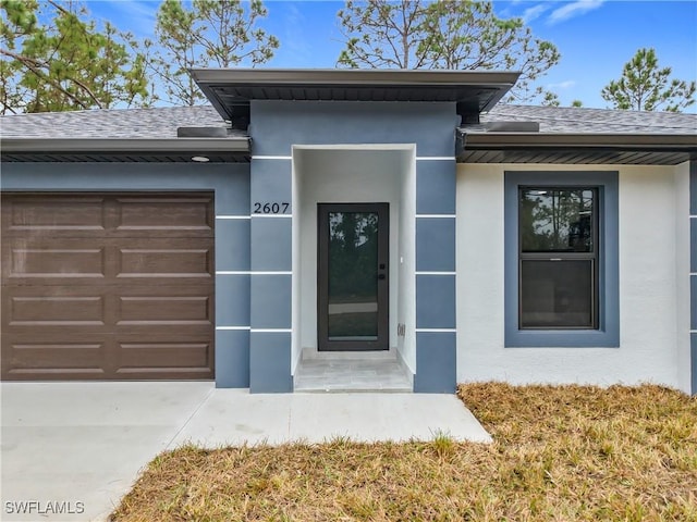 view of exterior entry featuring a garage