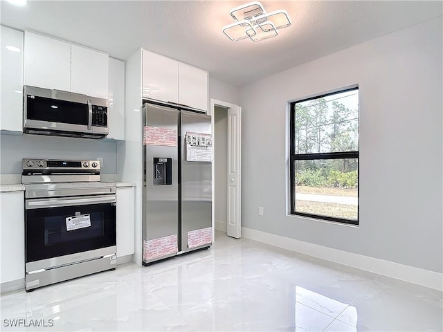 kitchen featuring appliances with stainless steel finishes and white cabinetry