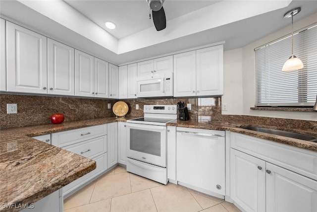 kitchen featuring light tile patterned flooring, tasteful backsplash, white cabinets, hanging light fixtures, and white appliances