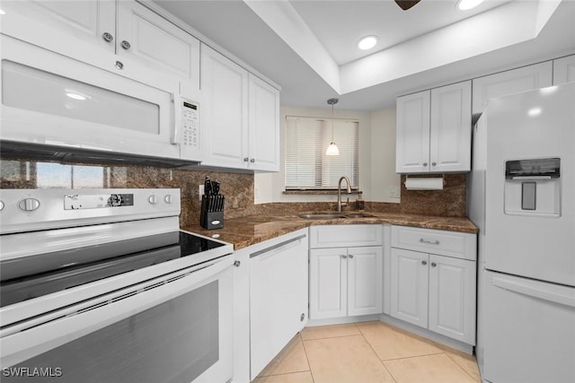 kitchen featuring sink, white cabinetry, pendant lighting, white appliances, and decorative backsplash