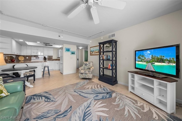 living room with light tile patterned floors and ceiling fan