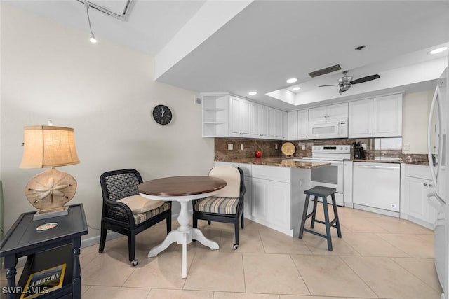 kitchen featuring light tile patterned floors, white appliances, ceiling fan, white cabinetry, and backsplash