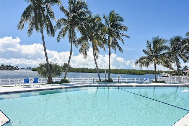 view of swimming pool featuring a water view