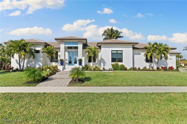 100 Templewood Ct, Marco Island, FL 34145 - prairie-style house with french doors, a front lawn, and stucco siding