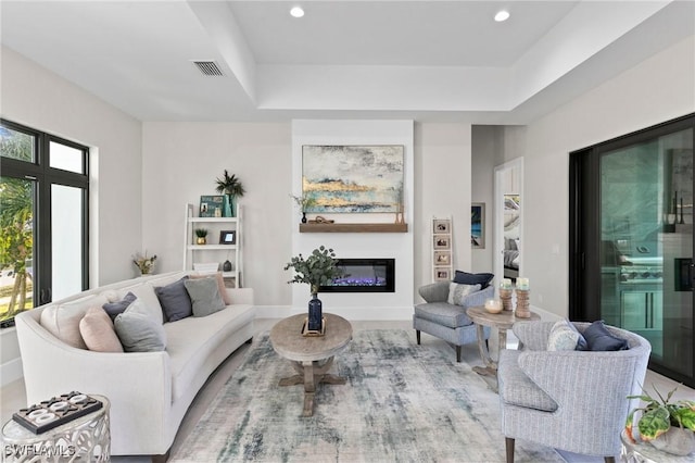 living room with a tray ceiling