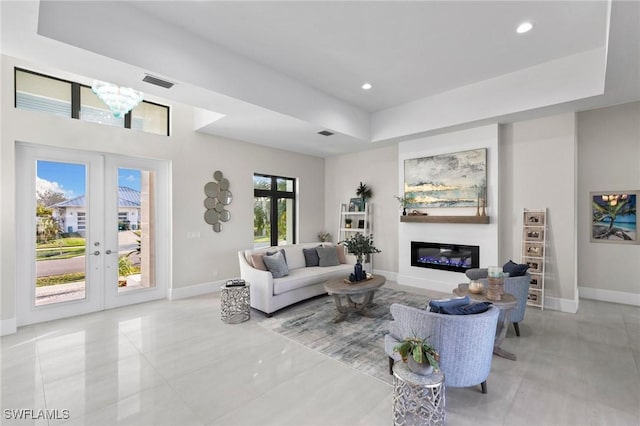 living room featuring french doors and a notable chandelier