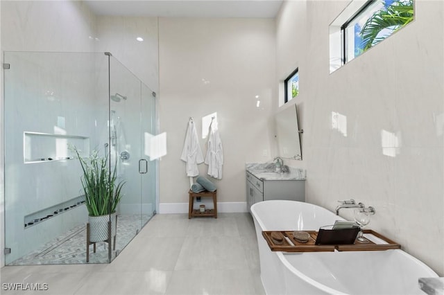 bathroom featuring vanity and shower with separate bathtub