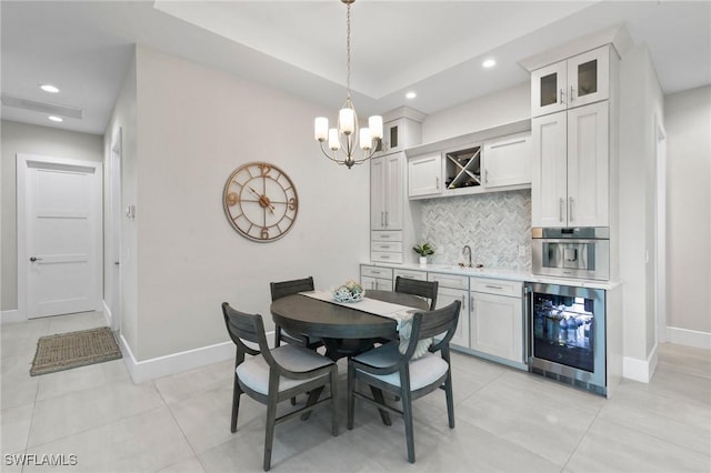 100 Templewood Ct, Marco Island, FL 34145 - dining area with beverage cooler, wet bar, baseboards, recessed lighting, and a chandelier