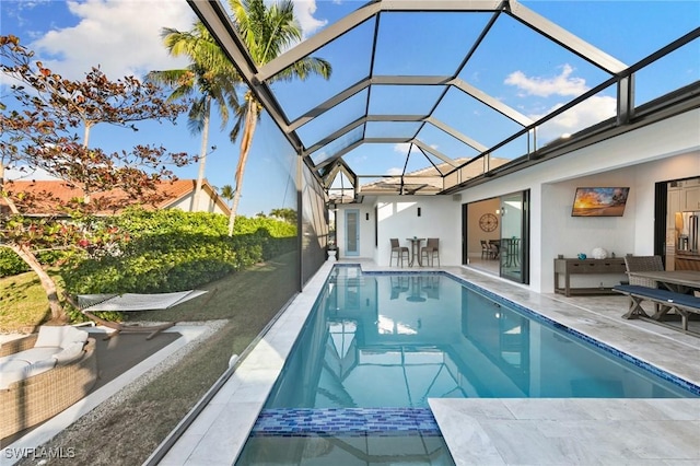 view of swimming pool with a lanai and a patio area