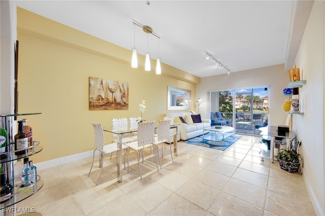 dining room featuring light tile patterned flooring and track lighting