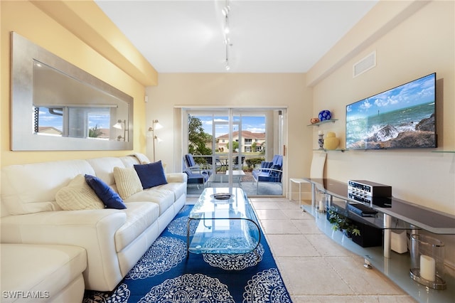 living room featuring light tile patterned floors and track lighting