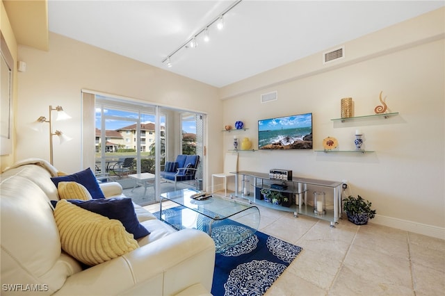 living room featuring light tile patterned flooring and rail lighting