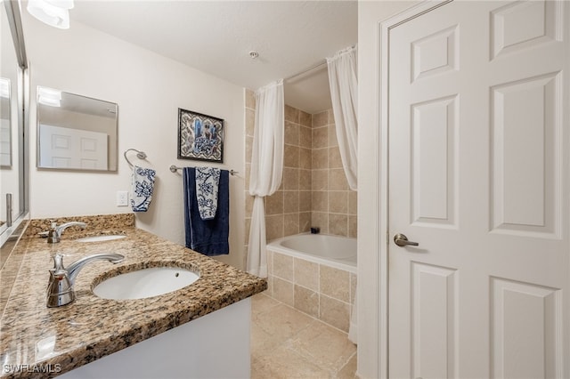 bathroom with shower / bath combo with shower curtain, tile patterned floors, and vanity