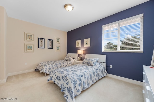 bedroom featuring light colored carpet