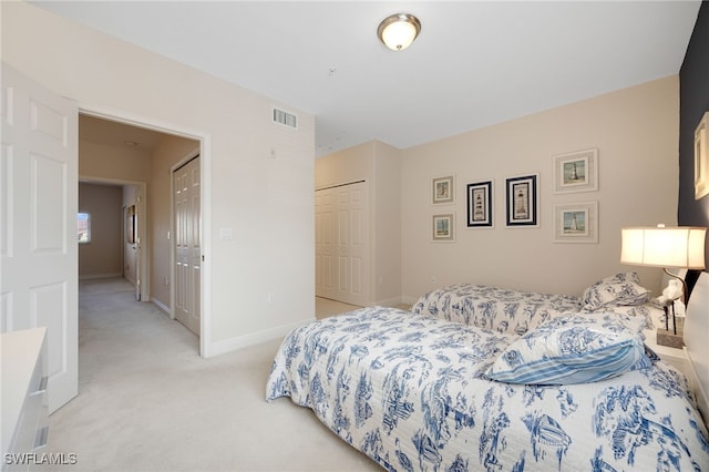 bedroom with a closet and light carpet