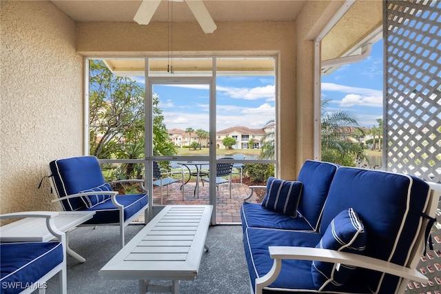 sunroom / solarium with beamed ceiling and ceiling fan